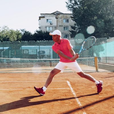 middle-aged-man-playing-tennis-on-outdoor-tennis-filed.jpg